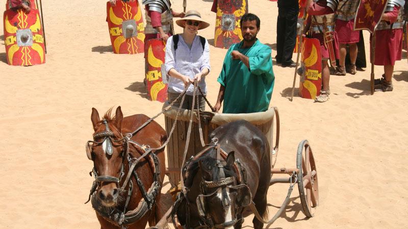 Archaeology student riding in a chariot